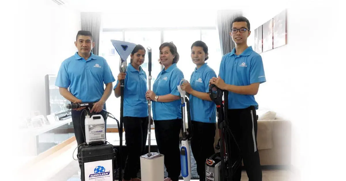 Sureclean team with cleaning equipment in a living room