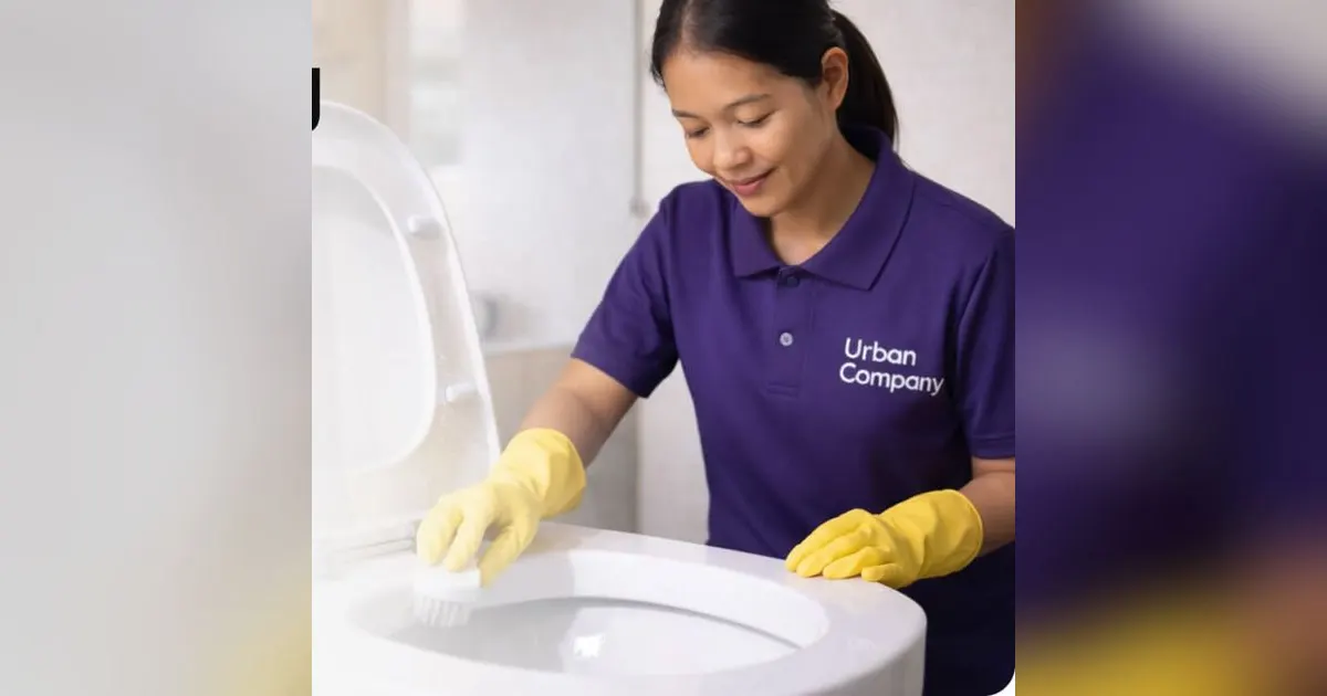 Urban Company cleaner cleaning a toilet