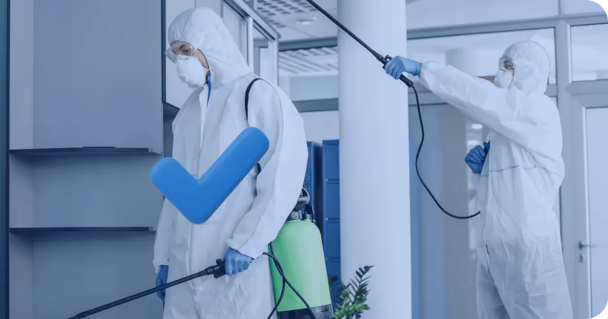 Luce technicians in protective suits spraying