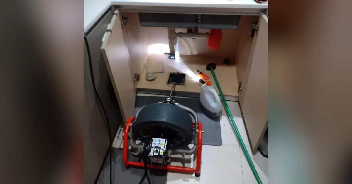 Family Plumber drain machine clearing a sink choke