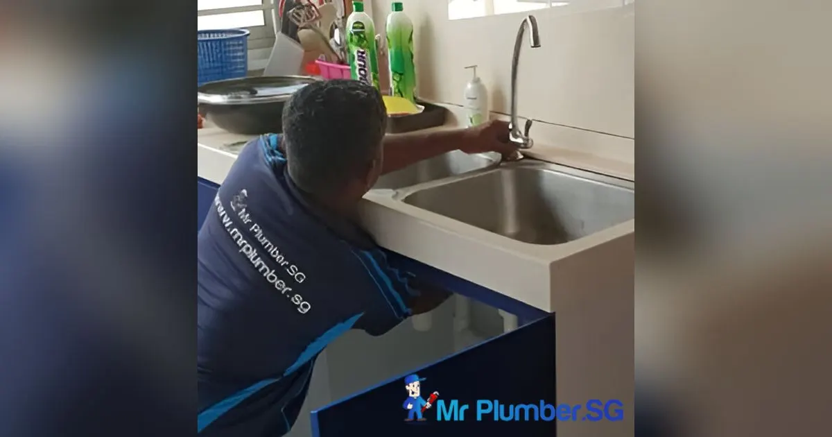 Mr Plumber technician repairing a kitchen sink tap
