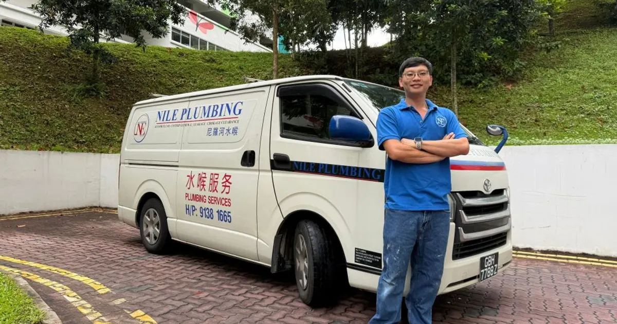 Nile Plumbing van with a plumber standing beside it